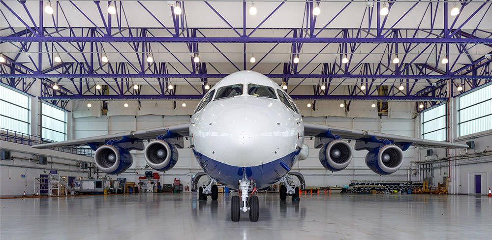 Large four-engine research aircraft inside a hangar