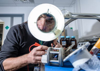 Scientist looking through a magnifying glass